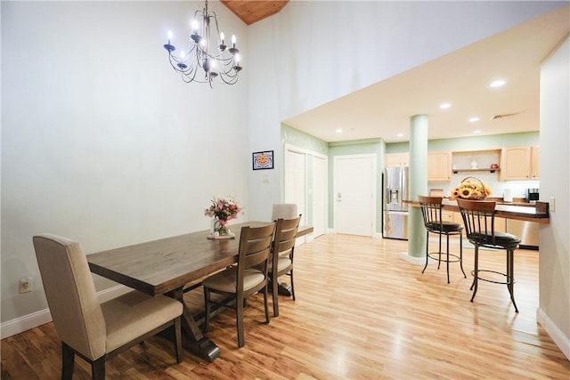 1 Tupperware Dr Unit 121, North Smithfield, RI 02896 - dining room featuring light wood-style floors, baseboards, a chandelier, recessed lighting, and a towering ceiling