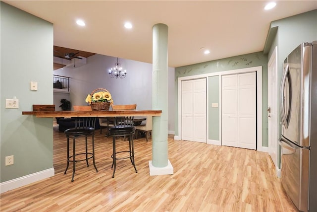 1 Tupperware Dr Unit 121, North Smithfield, RI 02896 - kitchen featuring freestanding refrigerator, wood finished floors, baseboards, recessed lighting, and a chandelier