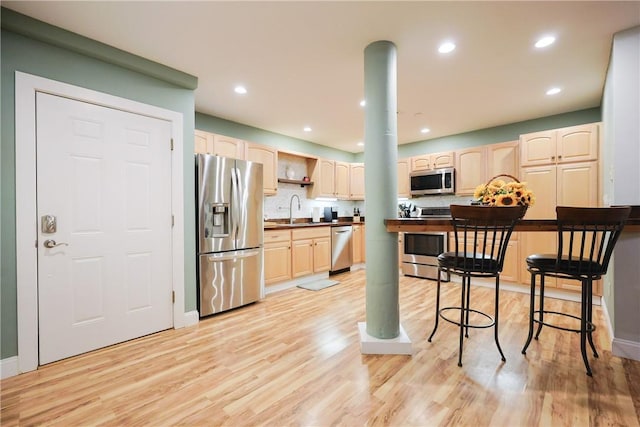 1 Tupperware Dr Unit 121, North Smithfield, RI 02896 - kitchen with stainless steel appliances, a sink, light brown cabinetry, light wood-type flooring, and recessed lighting