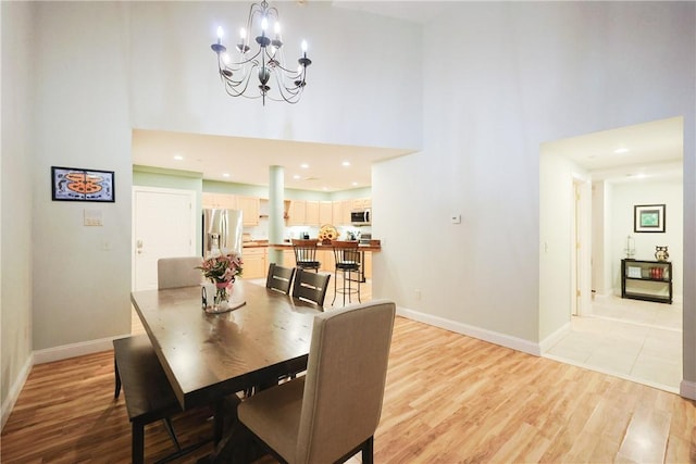 1 Tupperware Dr Unit 121, North Smithfield, RI 02896 - dining area featuring a towering ceiling, light wood-type flooring, a chandelier, baseboards, and recessed lighting