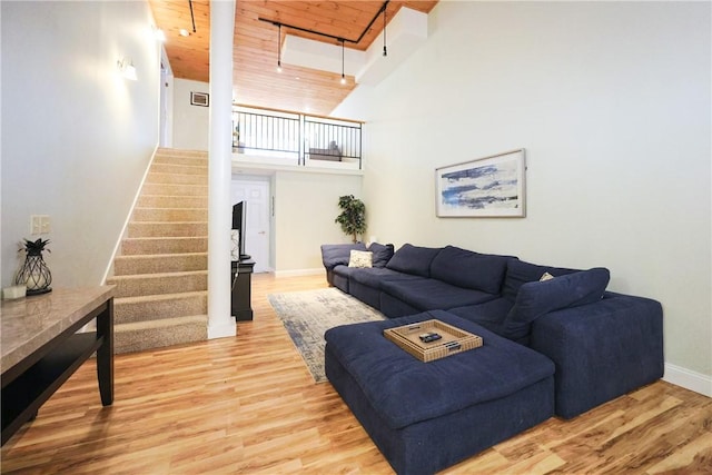 1 Tupperware Dr Unit 121, North Smithfield, RI 02896 - living area with wood ceiling, a towering ceiling, stairs, baseboards, and wood finished floors