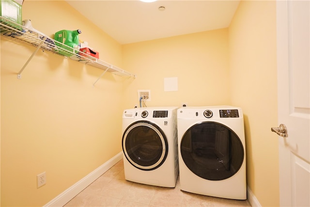 1 Tupperware Dr Unit 121, North Smithfield, RI 02896 - washroom featuring washing machine and clothes dryer, light tile patterned floors, and baseboards