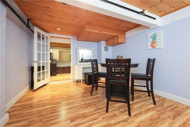 1 Tupperware Dr Unit 121, North Smithfield, RI 02896 - dining room with wood ceiling, wood finished floors, baseboards, and brick wall