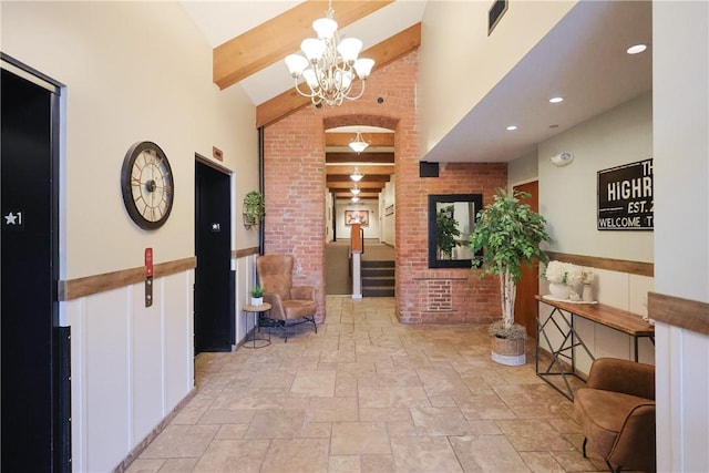 1 Tupperware Dr Unit 121, North Smithfield, RI 02896 - hall featuring beam ceiling, stone tile floors, a chandelier, and high vaulted ceiling