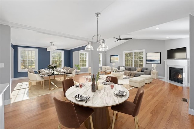 117 Mann School Rd, Smithfield, RI 02917 - dining area featuring light wood-type flooring, vaulted ceiling, baseboards, a fireplace with flush hearth, and recessed lighting