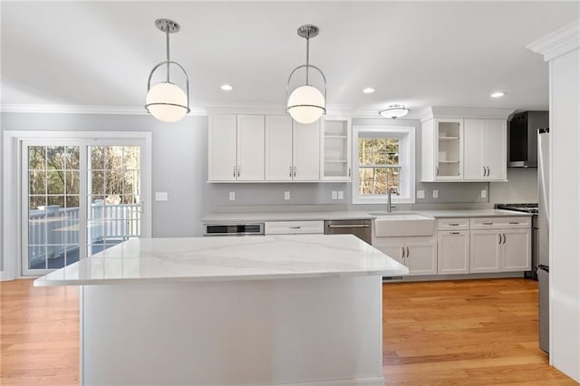 117 Mann School Rd, Smithfield, RI 02917 - kitchen featuring a sink, ornamental molding, white cabinets, healthy amount of natural light, and glass insert cabinets