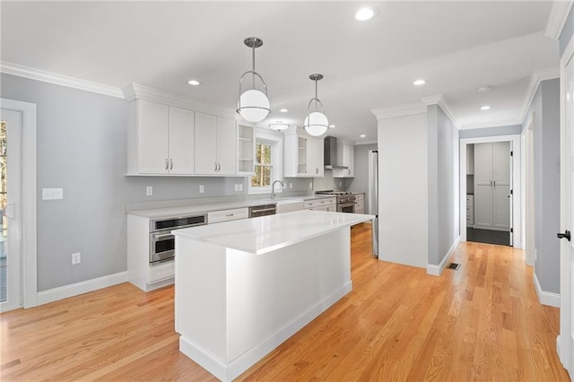 117 Mann School Rd, Smithfield, RI 02917 - kitchen with wall chimney exhaust hood, stainless steel appliances, white cabinets, light countertops, and ornamental molding
