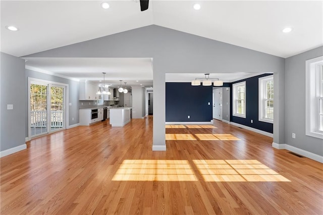 117 Mann School Rd, Smithfield, RI 02917 - unfurnished living room featuring a chandelier, vaulted ceiling, light wood finished floors, recessed lighting, and baseboards