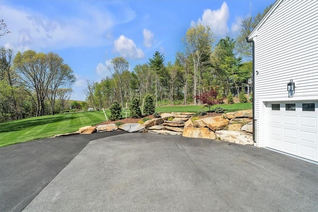 117 Mann School Rd, Smithfield, RI 02917 - view of patio / terrace with a garage and asphalt driveway