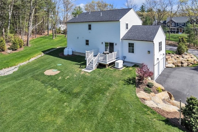 117 Mann School Rd, Smithfield, RI 02917 - rear view of property with a deck, driveway, a shingled roof, a garage, and a lawn