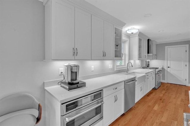 117 Mann School Rd, Smithfield, RI 02917 - kitchen with appliances with stainless steel finishes, a sink, white cabinetry, light countertops, and glass insert cabinets