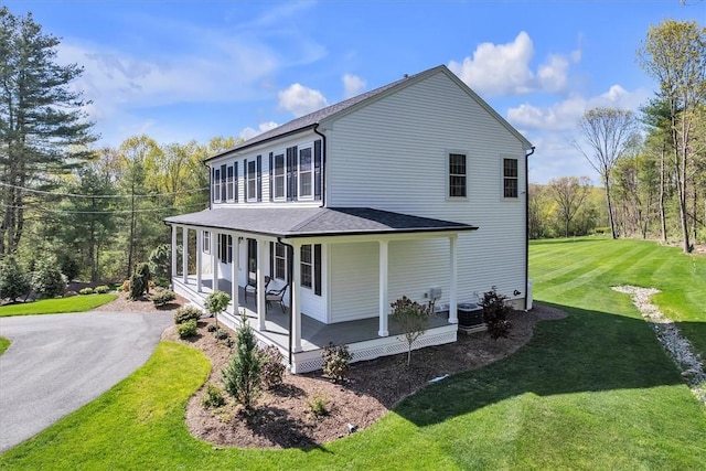 117 Mann School Rd, Smithfield, RI 02917 - view of side of property with covered porch, a yard, roof with shingles, central air condition unit, and asphalt driveway