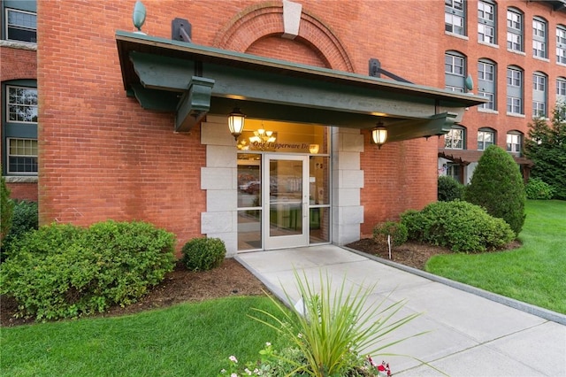 1 Tupperware Dr Unit 226, North Smithfield, RI 02896 - property entrance featuring brick siding and a yard