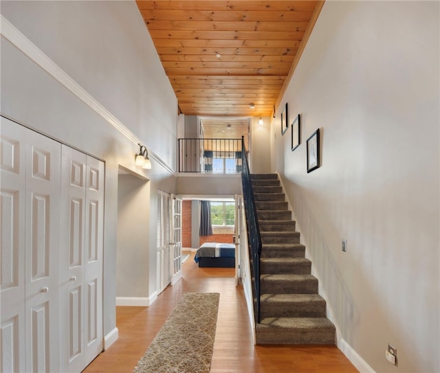 1 Tupperware Dr Unit 226, North Smithfield, RI 02896 - staircase featuring a towering ceiling, wood ceiling, and wood finished floors