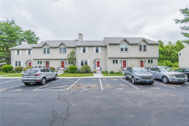 26 Noel Ct, South Kingstown, RI 02879 - view of front of home with uncovered parking and a chimney