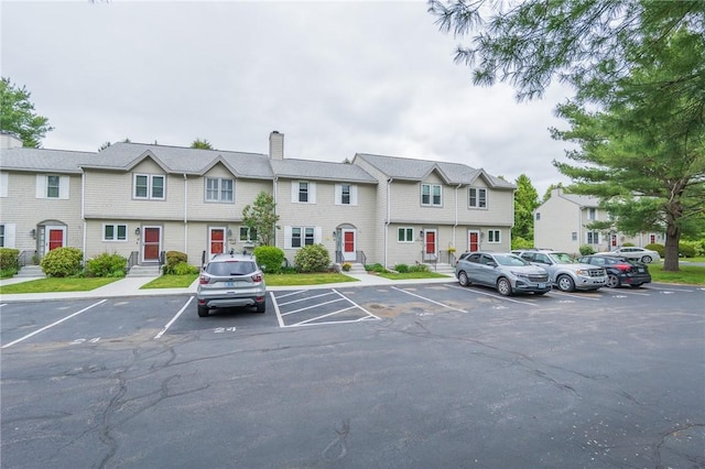 26 Noel Ct, South Kingstown, RI 02879 - view of building exterior featuring uncovered parking and a residential view