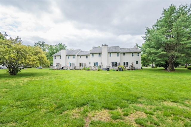 26 Noel Ct, South Kingstown, RI 02879 - back of house featuring a yard