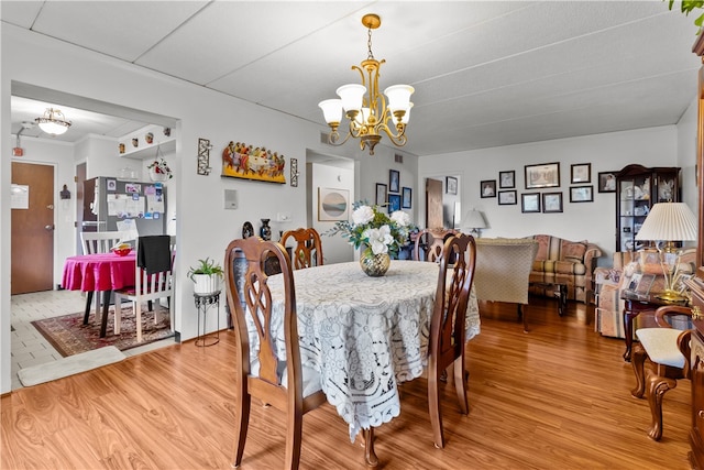 510 Child St Unit 105B, Warren, RI 02885 - dining area with a chandelier and wood finished floors