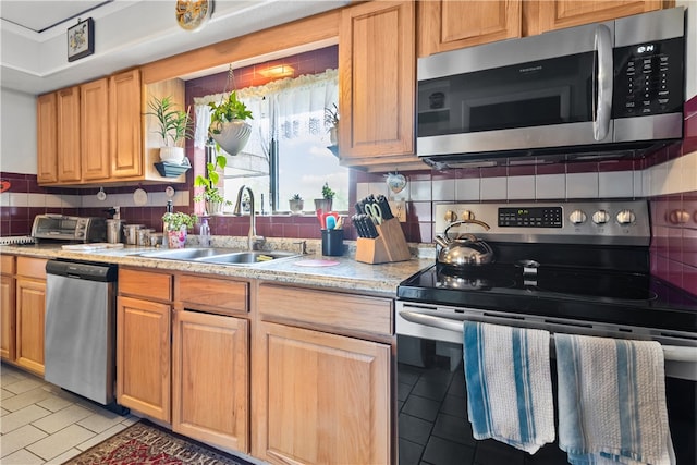 510 Child St Unit 105B, Warren, RI 02885 - kitchen with stainless steel appliances, a sink, tasteful backsplash, and light tile patterned floors