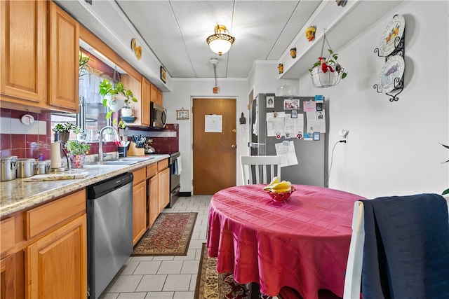 510 Child St Unit 105B, Warren, RI 02885 - kitchen featuring stainless steel appliances, a sink, tasteful backsplash, light stone countertops, and light tile patterned floors