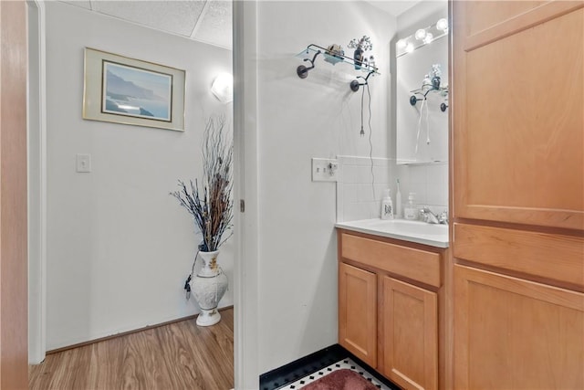 510 Child St Unit 105B, Warren, RI 02885 - bathroom with vanity, tasteful backsplash, and wood finished floors