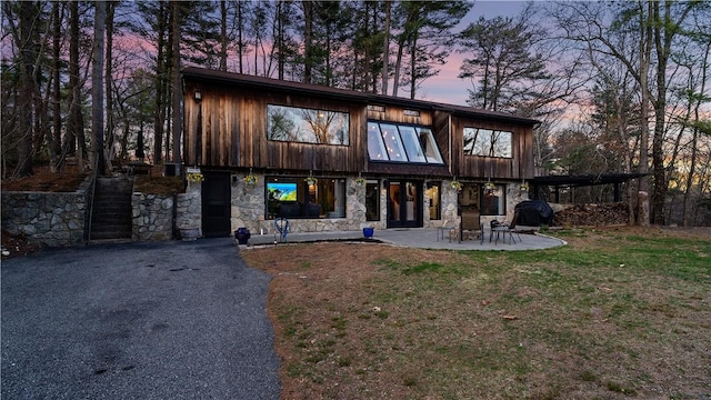 25 Mountaindale Rd, Smithfield, RI 02917 - view of front of property featuring stone siding, a patio area, and a lawn