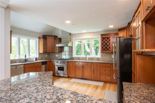 200 Miner Rd, North Kingstown, RI 02874 - kitchen with appliances with stainless steel finishes, wall chimney range hood, a sink, brown cabinets, and recessed lighting