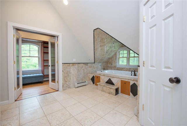 200 Miner Rd, North Kingstown, RI 02874 - full bathroom featuring a baseboard heating unit, vaulted ceiling, a garden tub, tile patterned flooring, and tile walls