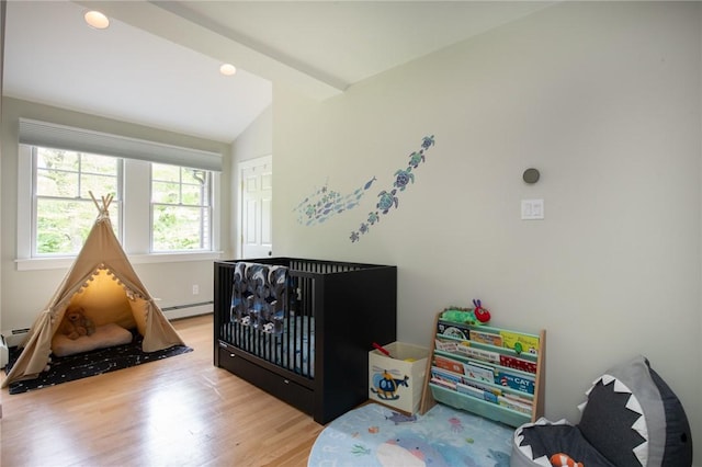 200 Miner Rd, North Kingstown, RI 02874 - bedroom featuring wood finished floors, vaulted ceiling, and baseboard heating