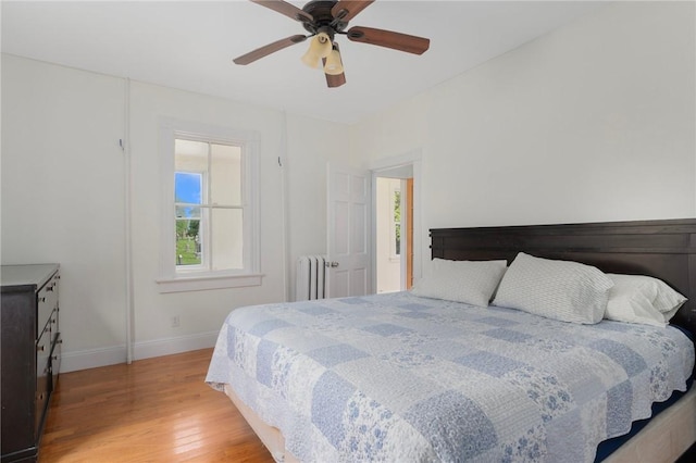 53 Warner St, Newport, RI 02840 - bedroom with light wood finished floors, multiple windows, baseboards, and radiator