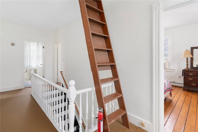 53 Warner St, Newport, RI 02840 - corridor featuring an upstairs landing, a baseboard heating unit, and wood-type flooring