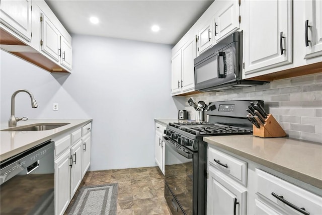 18 Caddy Rock Rd Unit C, North Kingstown, RI 02852 - kitchen featuring black appliances, a sink, decorative backsplash, white cabinets, and stone finish floors