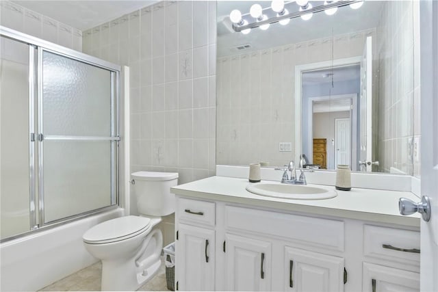 18 Caddy Rock Rd Unit C, North Kingstown, RI 02852 - bathroom featuring tile walls, vanity, toilet, bath / shower combo with glass door, and tile patterned flooring