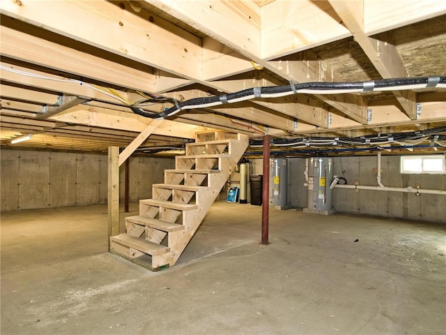 24 Seaspray Way, Little Compton, RI 02837 - unfinished below grade area with electric water heater, water heater, and stairs