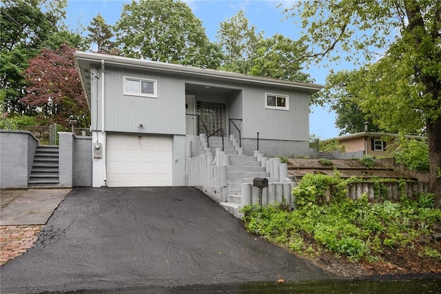 613 Prospect St, Woonsocket, RI 02895 - view of front facade with stairway, a garage, and driveway