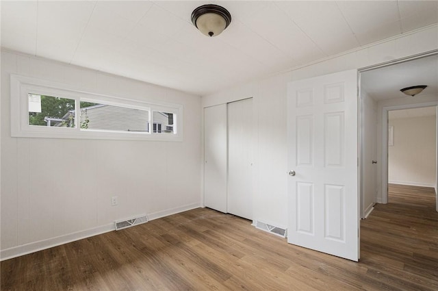 613 Prospect St, Woonsocket, RI 02895 - unfurnished bedroom with wood finished floors, a closet, and baseboards