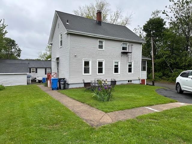 30 Pomham St, Cranston, RI 02910 - back of property featuring a chimney and a yard