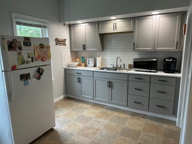 30 Pomham St, Cranston, RI 02910 - kitchen featuring freestanding refrigerator, gray cabinets, stainless steel microwave, a sink, and backsplash