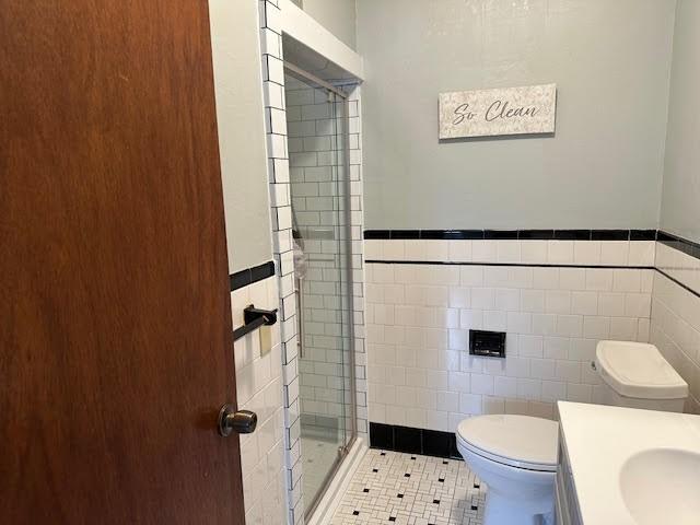 30 Pomham St, Cranston, RI 02910 - bathroom with tile walls, toilet, a stall shower, tile patterned floors, and vanity