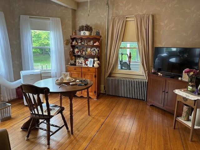 30 Pomham St, Cranston, RI 02910 - dining area with radiator, light wood-style flooring, and wallpapered walls