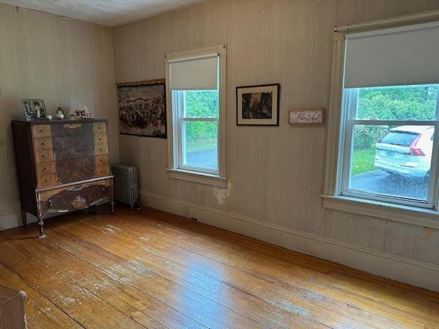 30 Pomham St, Cranston, RI 02910 - spare room featuring radiator, hardwood / wood-style floors, and plenty of natural light