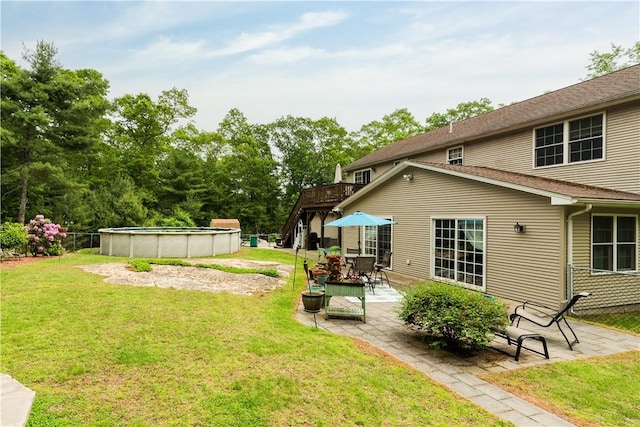 187 Plainfield Pike, Scituate, RI 02857 - view of green lawn with an outdoor pool, a deck, and a patio