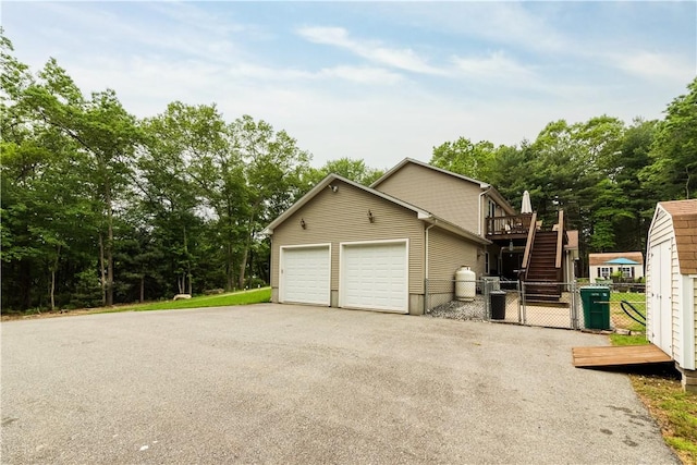 187 Plainfield Pike, Scituate, RI 02857 - garage featuring asphalt driveway and a gate