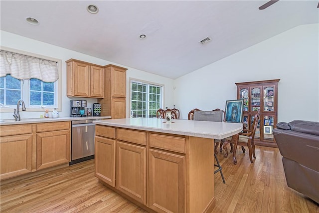 187 Plainfield Pike, Scituate, RI 02857 - kitchen with vaulted ceiling, a sink, a breakfast bar area, light wood-style floors, and dishwasher