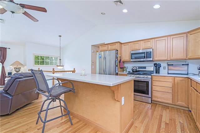 187 Plainfield Pike, Scituate, RI 02857 - kitchen with stainless steel appliances, lofted ceiling, open floor plan, a kitchen breakfast bar, and light wood-style floors