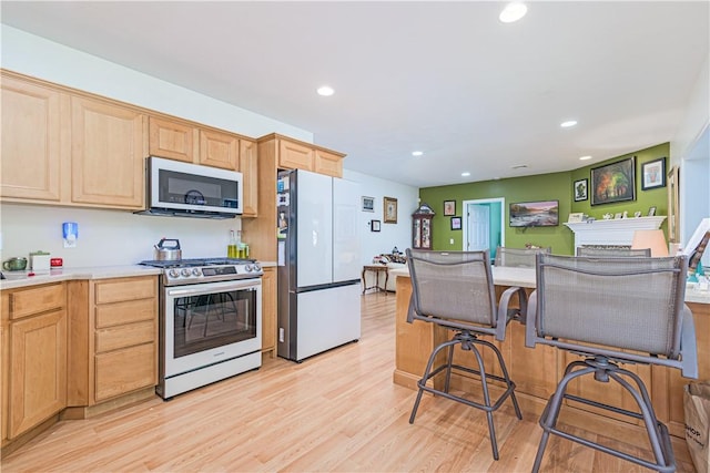 187 Plainfield Pike, Scituate, RI 02857 - kitchen featuring stainless steel appliances, light brown cabinets, recessed lighting, light wood-style floors, and light countertops