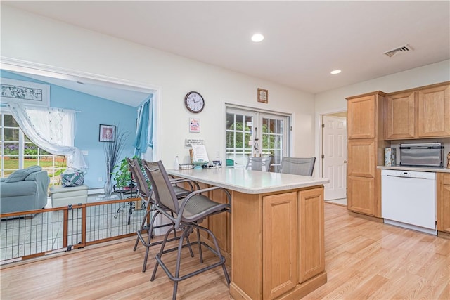 187 Plainfield Pike, Scituate, RI 02857 - kitchen featuring white dishwasher, french doors, light wood finished floors, a breakfast bar area, and recessed lighting