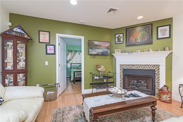 187 Plainfield Pike, Scituate, RI 02857 - living room with wood finished floors, baseboards, a tiled fireplace, and recessed lighting