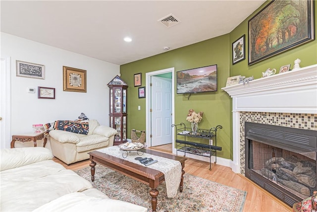 187 Plainfield Pike, Scituate, RI 02857 - living room with a tile fireplace, light wood-style flooring, and recessed lighting