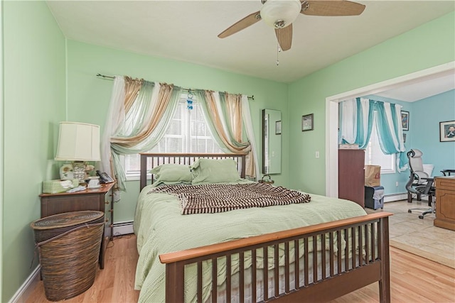 187 Plainfield Pike, Scituate, RI 02857 - bedroom with a baseboard heating unit, multiple windows, and light wood-type flooring